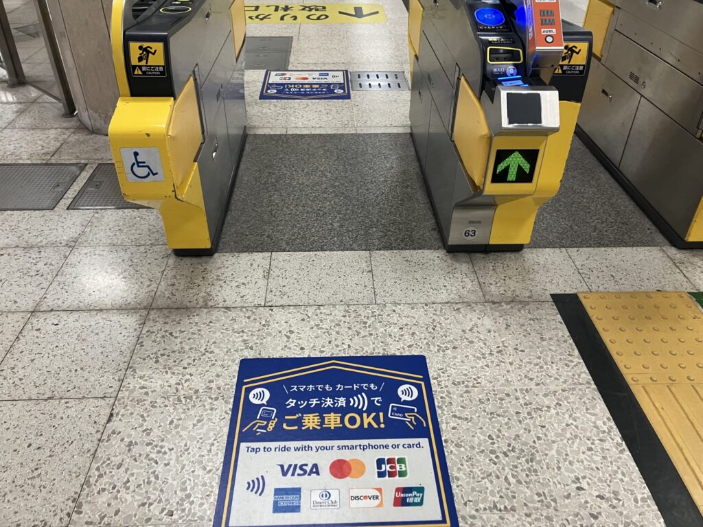 Not every subway gate supports contactless payment yet, so look for gates with the credit card/tap payment signs like this.